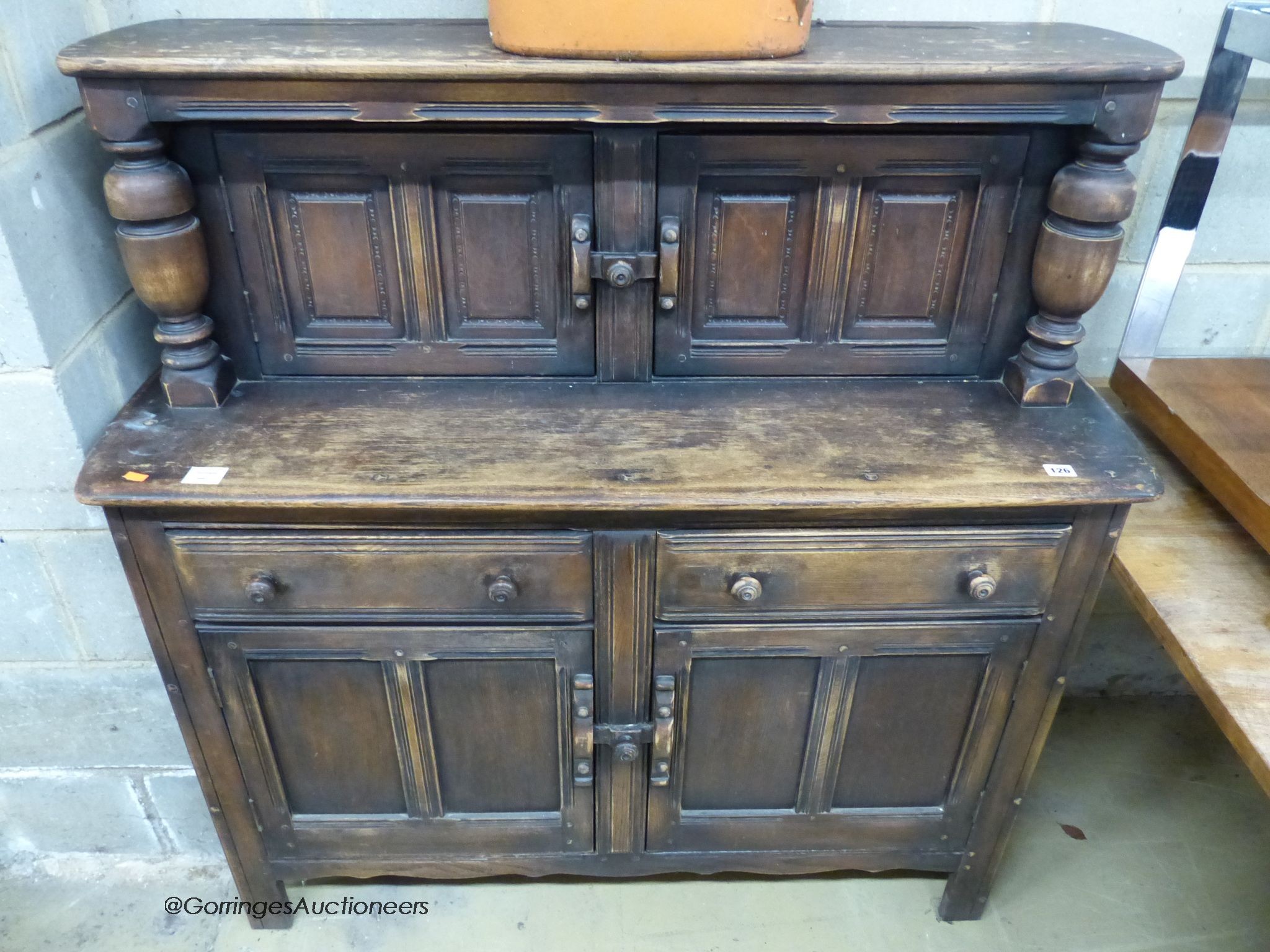 An Ercol oak court cupboard, length 122cm, depth 45cm, height 124cm